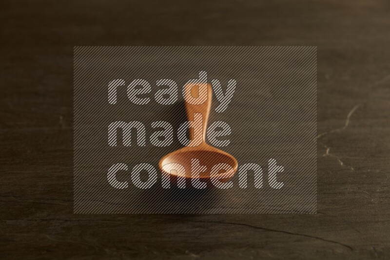 wooden spoon on black slate background