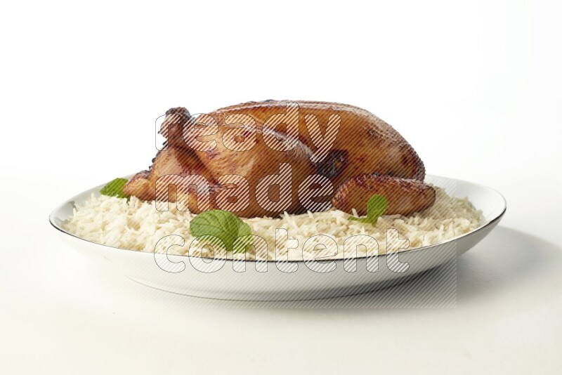 white  basmati Rice with  whole roasted chicken  on a white plate with a silver rim direct  on white background