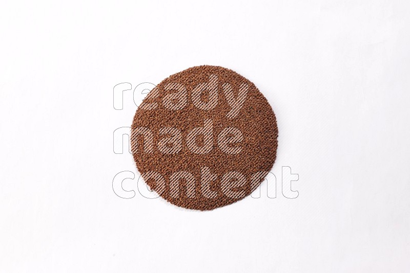Garden cress seeds in a circle shape on a white flooring