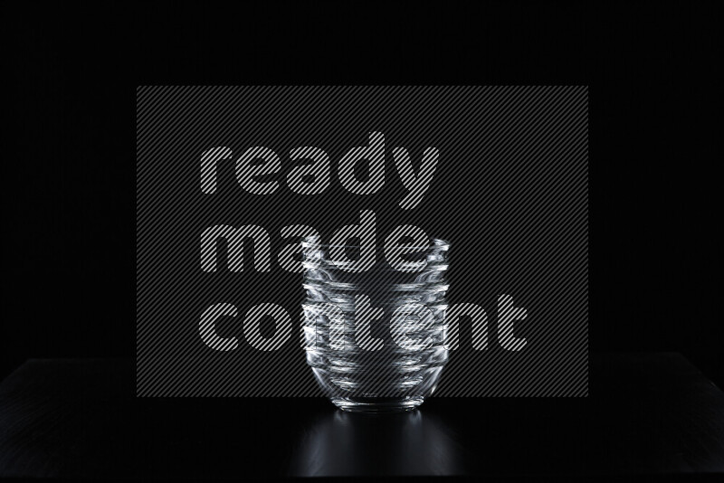 Glassware with rim light against black background