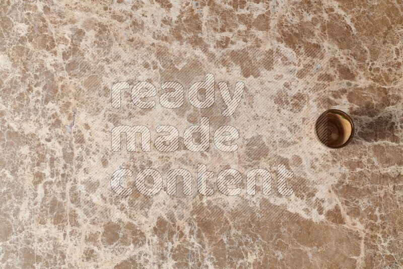 A pottery cup on beige marble background