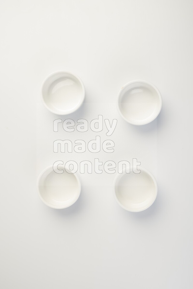 white ceramic round sauce dish on white countertop