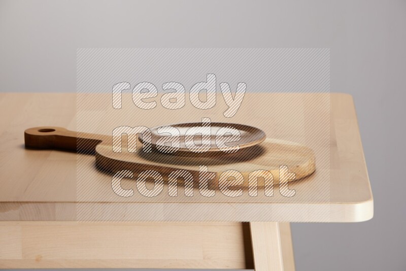 multi colored plate placed on a  wooden oval cutting board on the edge of wooden table