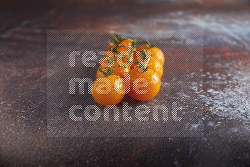 Orange cherry tomato vein on reddish rustic metal background 45 degree