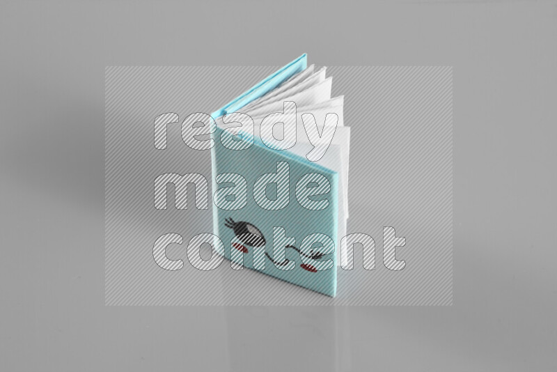 Origami book on grey background