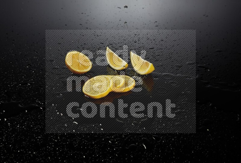 Lemon slices with water drops, and droplets on black background