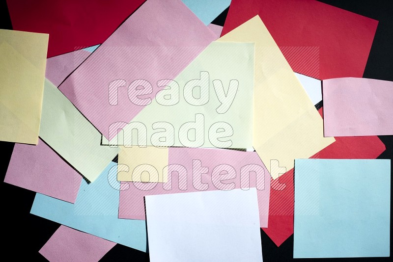 Multicolored paper sheet on black background