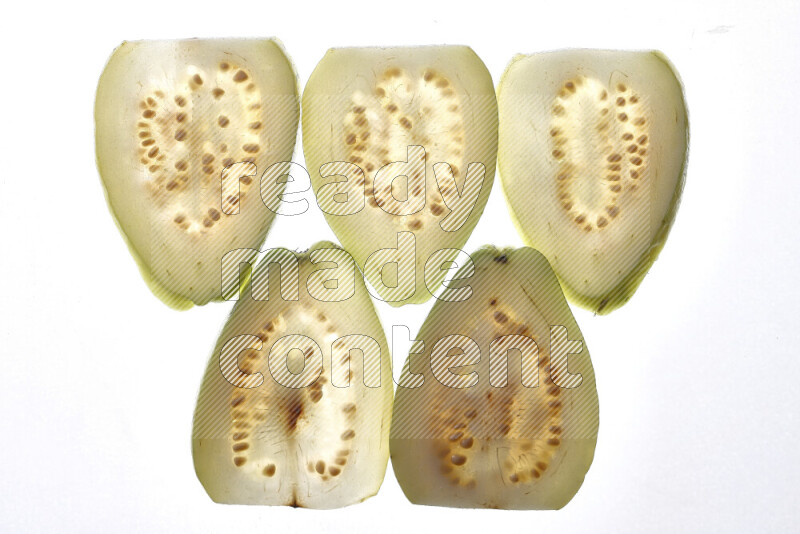 Guava slices on illuminated white background