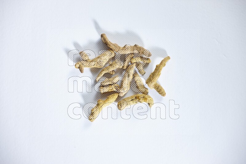 Dried turmeric whole fingers on white flooring