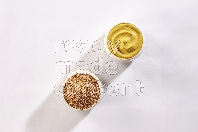 2 beige pottery bowls full of mustard seeds and mustard paste on white flooring in different angles
