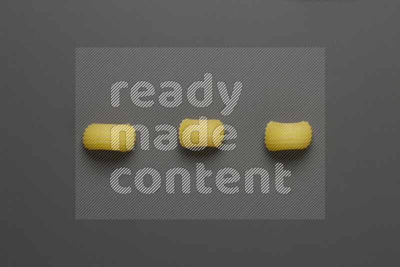 Elbow pasta on grey background