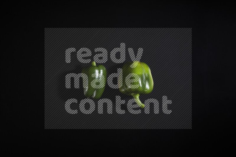 Green bell pepper on black background