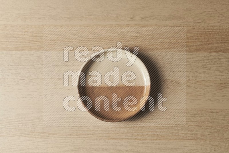 Top View Shot Of A Multicolored Pottery Oven Plate on Oak Wooden Flooring