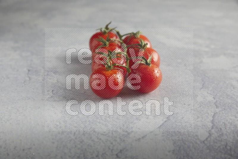 Red cherry tomato vein on a light grey textured background 45 degree