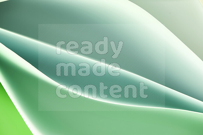 This image showcases an abstract paper art composition with paper curves in green gradients created by colored light