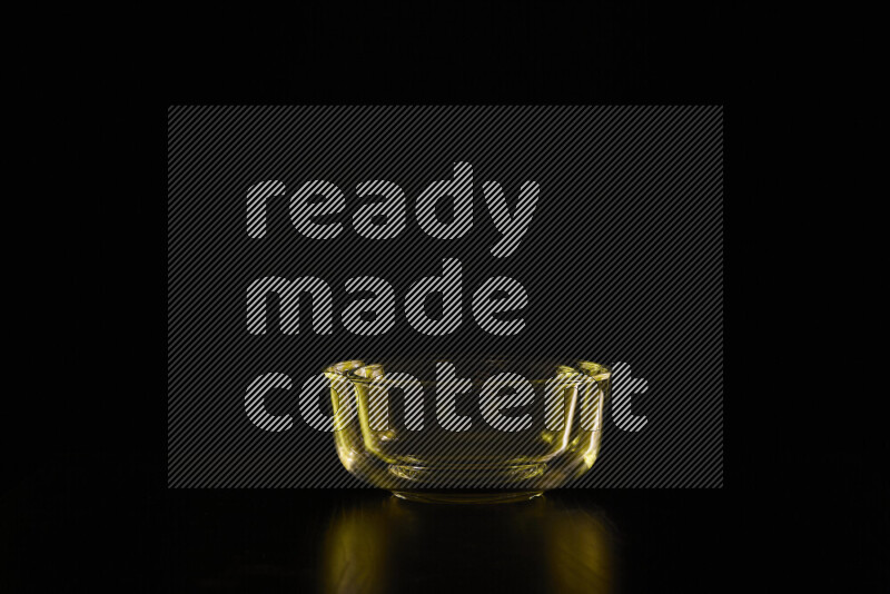 Glassware with rim light in yellow against black background