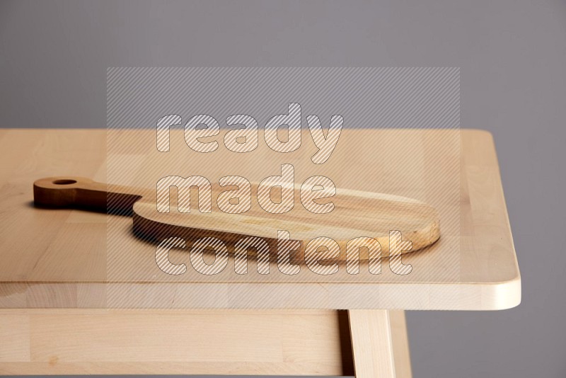 wooden trays and cutting boards on the edge of wooden table