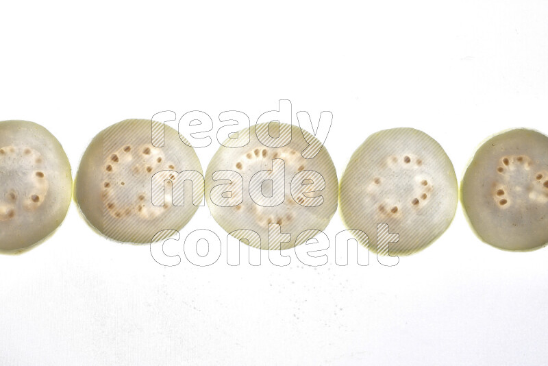Guava slices on illuminated white background