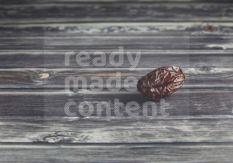 one madjoul date on a wooden grey background