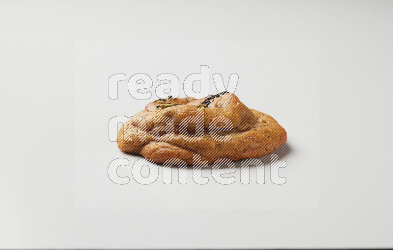 Hasawi cookie field with date and decorated by black seed and Anise grain on a white background