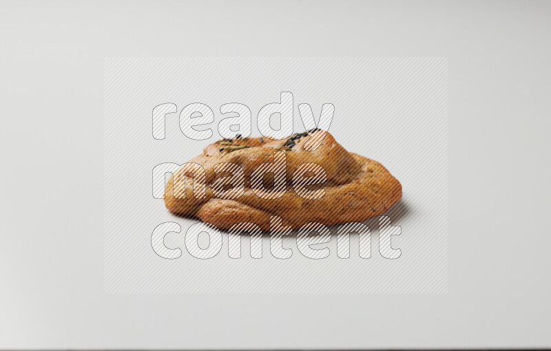 Hasawi cookie field with date and decorated by black seed and Anise grain on a white background