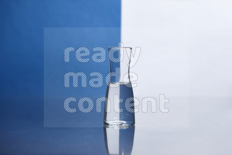 The image features a clear glassware filled with water, set against white and blue background