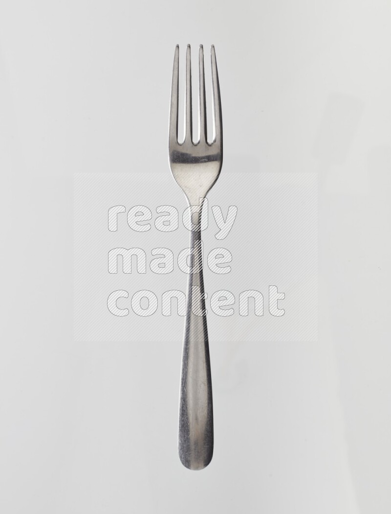 Silver stainless steel fork on white background