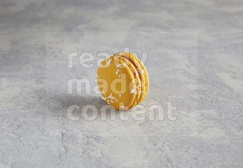45º Shot of Yellow Piña Colada macaron on white  marble background