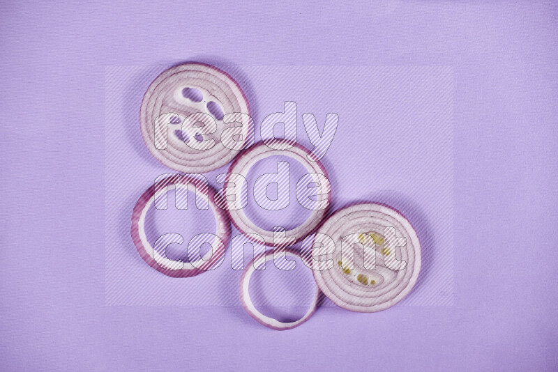 Red onions rings on purple background