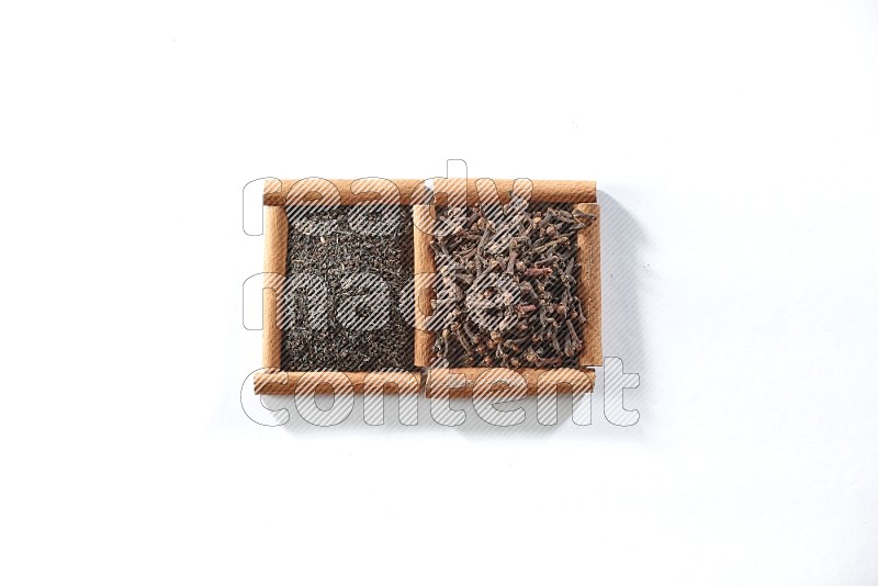 2 squares of cinnamon sticks full of black tea and cloves on white flooring