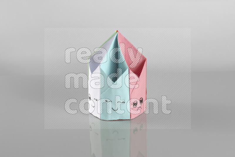 Origami pen holder on grey background