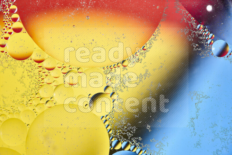 Close-ups of abstract oil bubbles on water surface in shades of yellow, red and blue