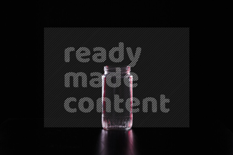 Glassware with rim light in red and white against black background