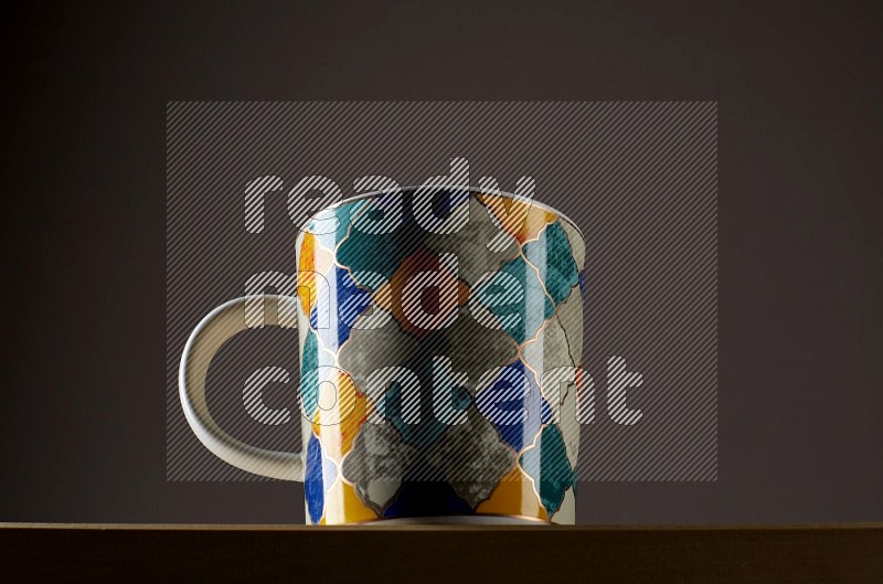 Low angle shot of a decorated cup on grey background