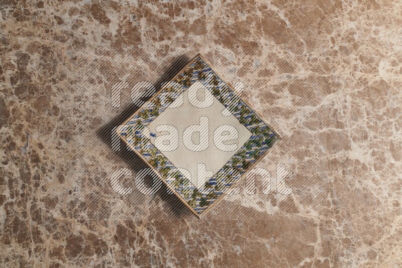 A decorative pottery plate on beige marble background