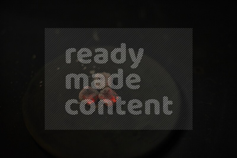 Burning coal cubes on pottery plate