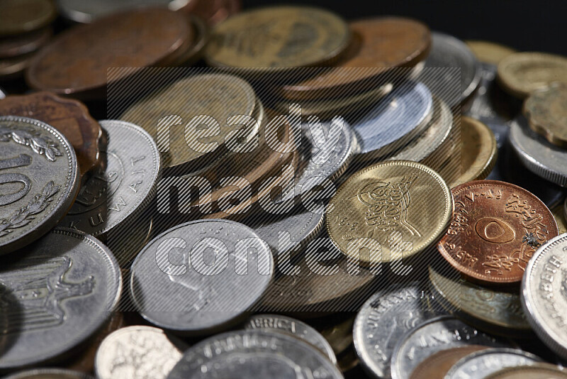 A close-ups of random old coins on black background