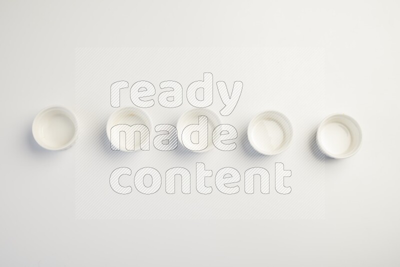 white ceramic round sauce dish on white countertop