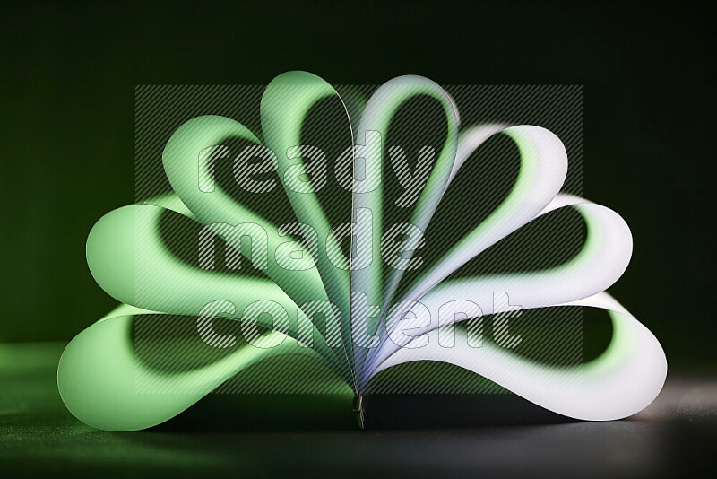 An abstract art piece displaying smooth curves in green and white gradients created by colored light