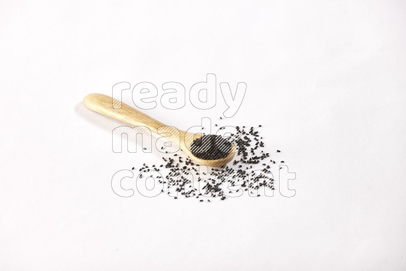 A wooden spoon full of black seeds on a white flooring in different angles