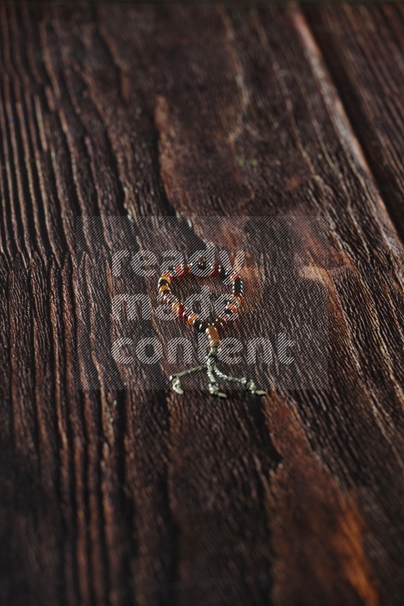 A prayer beads placed on wooden background