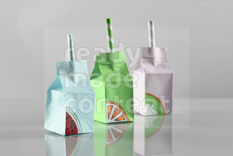 Origami juice box on grey background