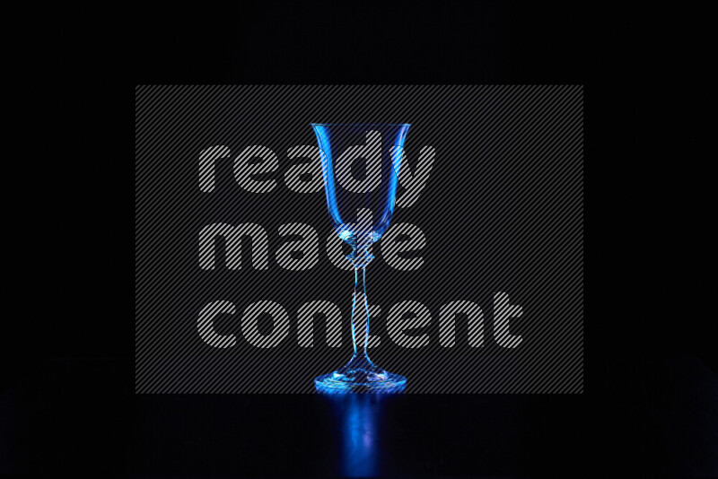 Glassware with rim light in blue against black background