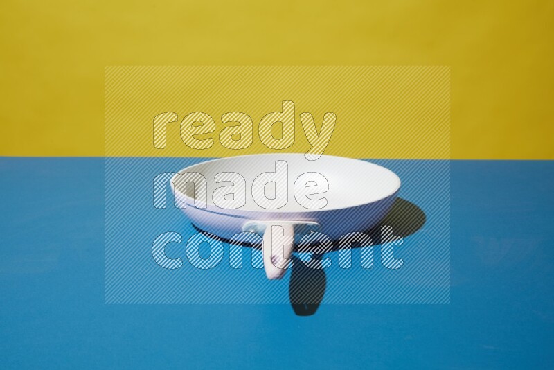 white pan on yellow and Blue background