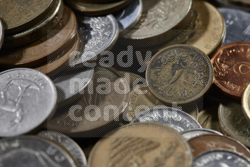 A close-ups of random old coins on black background