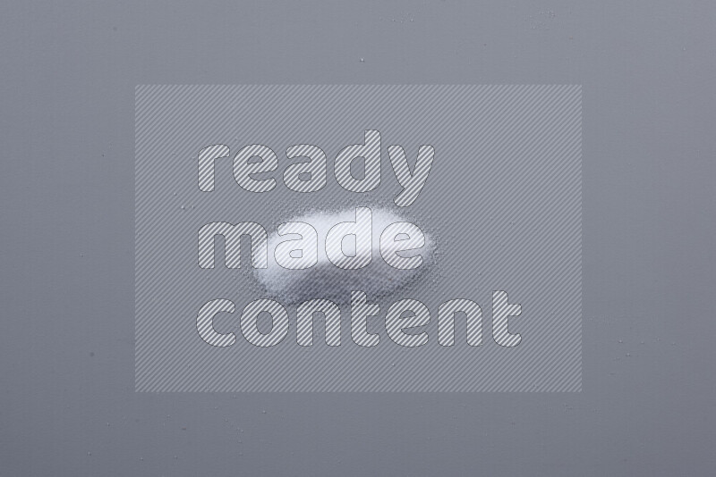 Bunches of table salt, coarse sea salt, fine himalayan salt and coarse himalayan salt on grey background