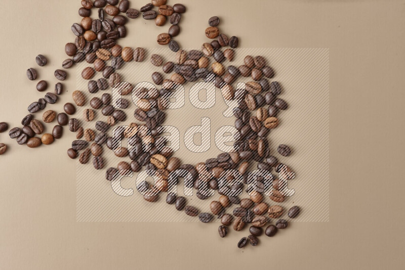 Roasted coffee beans on beige background