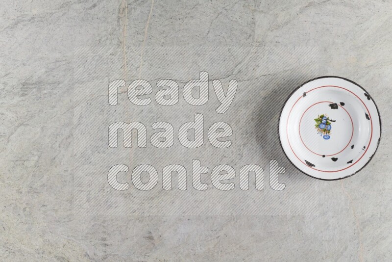 A vintage metal plate on grey marble background