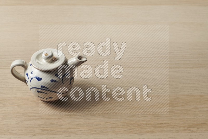 Pottery Teapot on Oak Wooden Flooring, 45 degrees