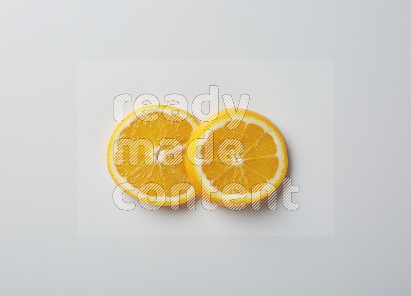 Two orange slices on white background